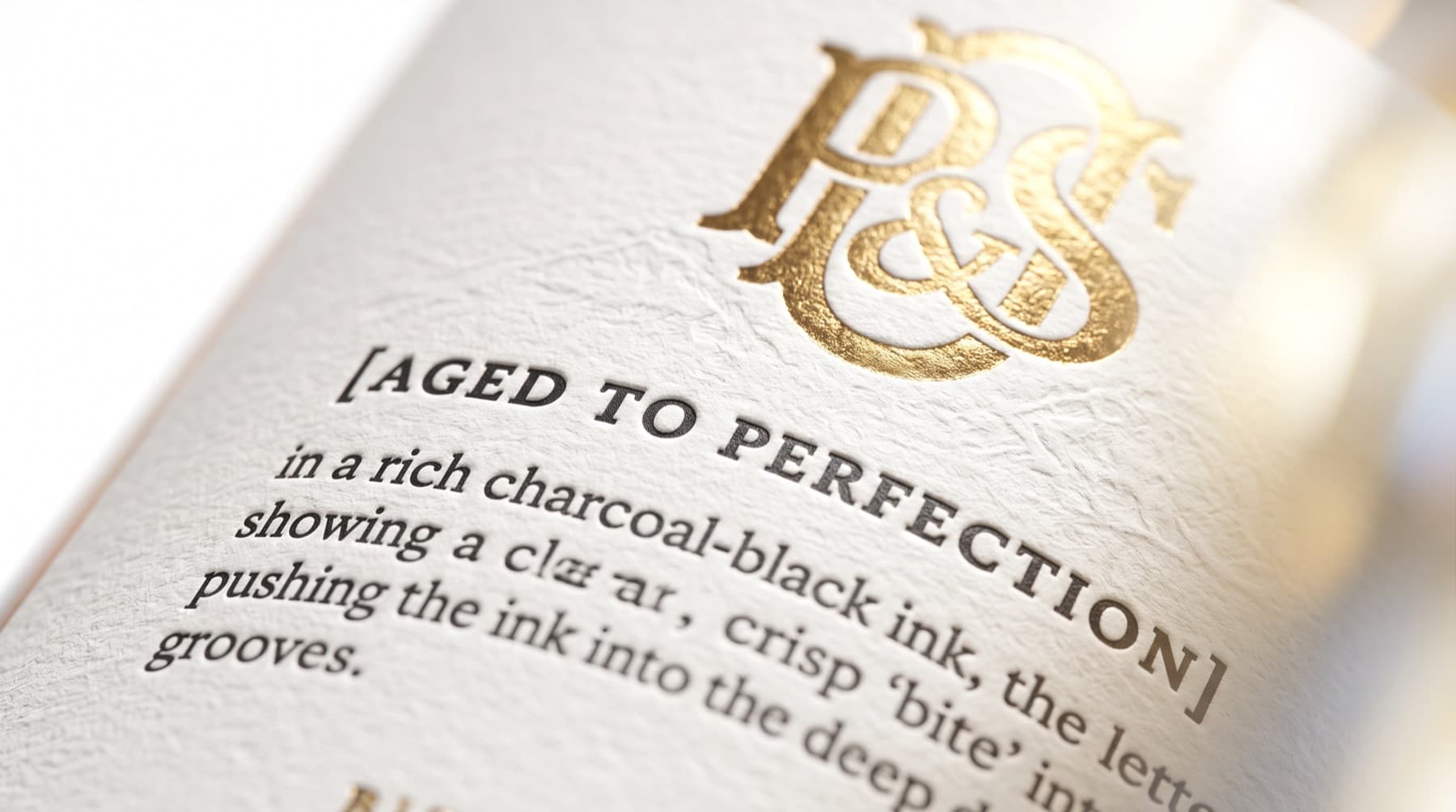 Gold foil monogram and letterpress print detail on a Loft House spirits label